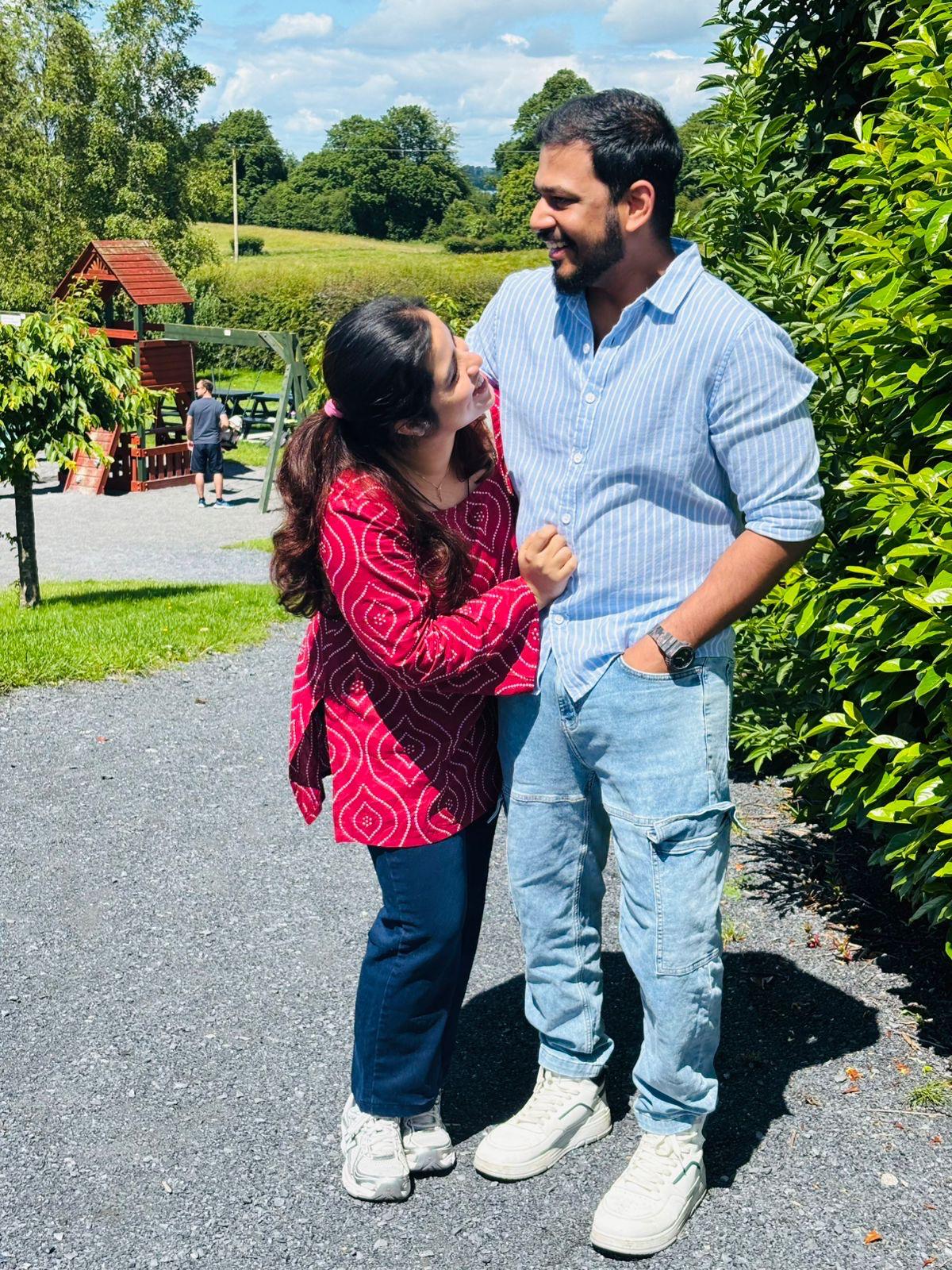 Anju looking up at Leyo as they share a smile on a sunny day.